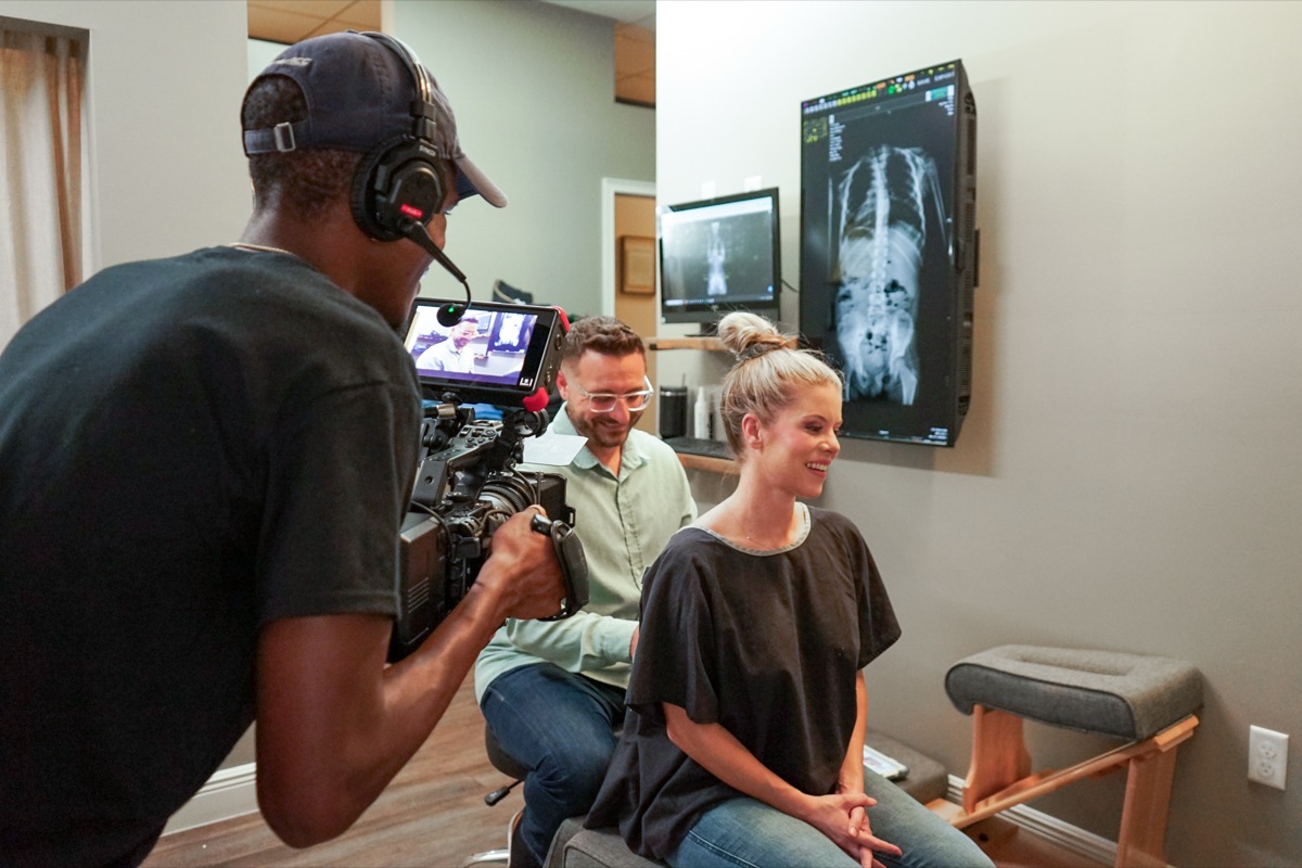 Filming a patient consultation in front of a spine x-ray